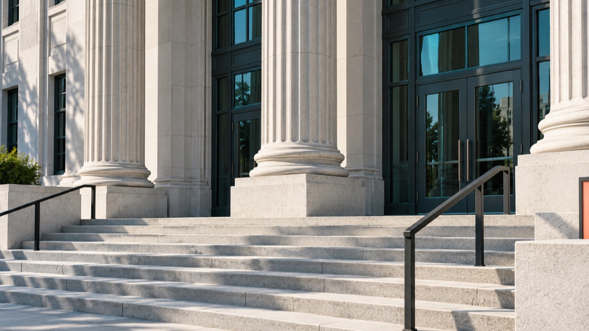 Illustrative civic courthouse entrance with stone columns and broad steps